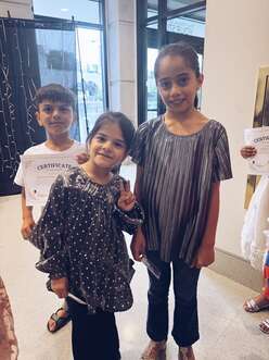 3 children smiling at camera